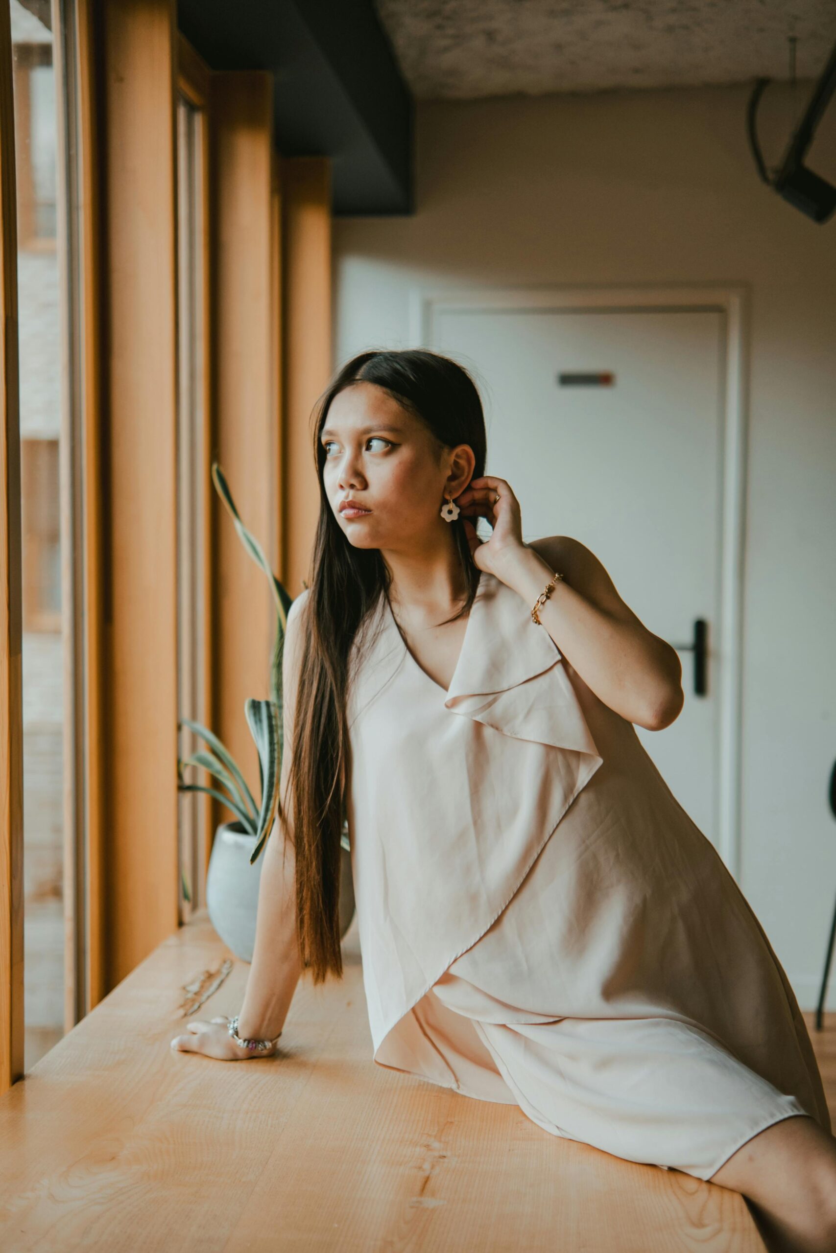 Portrait of a stylish young woman in a chic setting, exuding elegance.